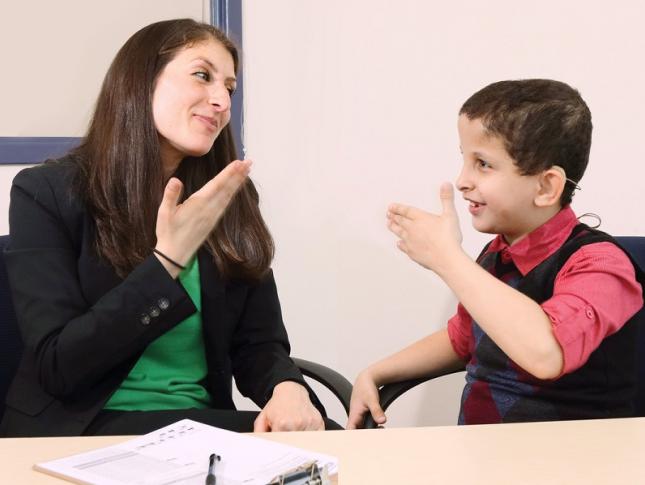 A teacher and student signing