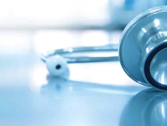 A stethoscope for sits on medical laboratory table. The background of the image is faded.