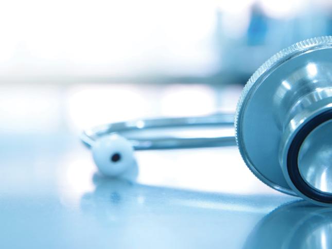 A stethoscope for sits on medical laboratory table. The background of the image is faded.