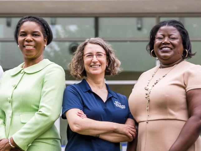 Five doctors stand in Kennedy Krieger Institute's therapy garden.