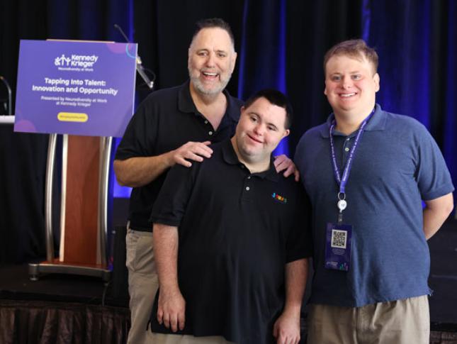 Three men smile in a photo at the Tapping into Talent Conference.