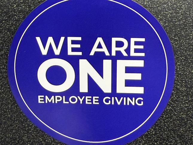 Blue magnet that says, We Are One Employee Giving.