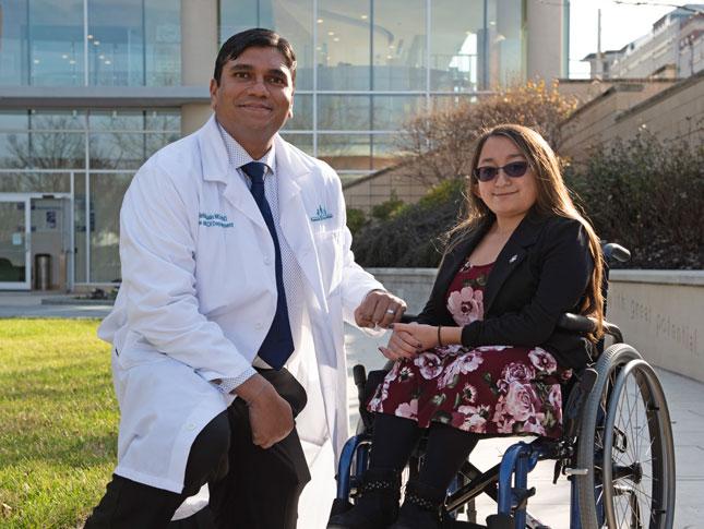 Dr. Mahim Jain and Shannon, a patient, in Kennedy Krieger's therapy garden