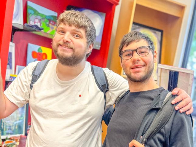 Two Neurodiversity at Work interns smile while.