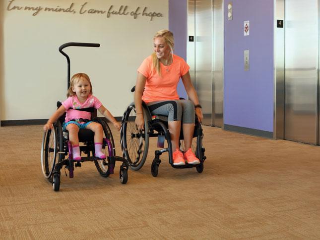 Two people in wheelchairs.