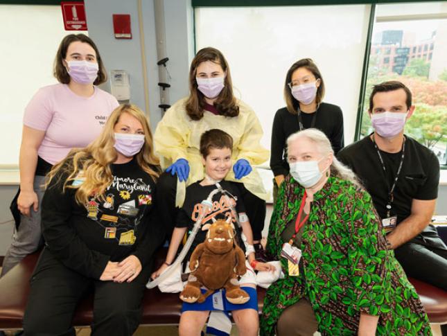 A young boy with his care team at Kennedy Krieger