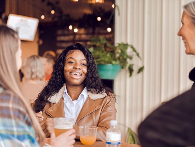 A woman smiles while attending a WIN event.
