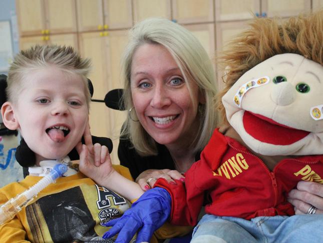 A WIN member gives a doll to a young boy.