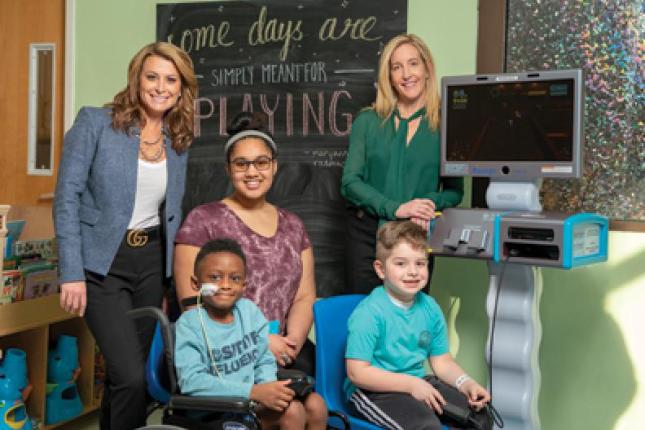 Lisa Vogel and Aimee Fulchino with patients and the Starlight Fun Center