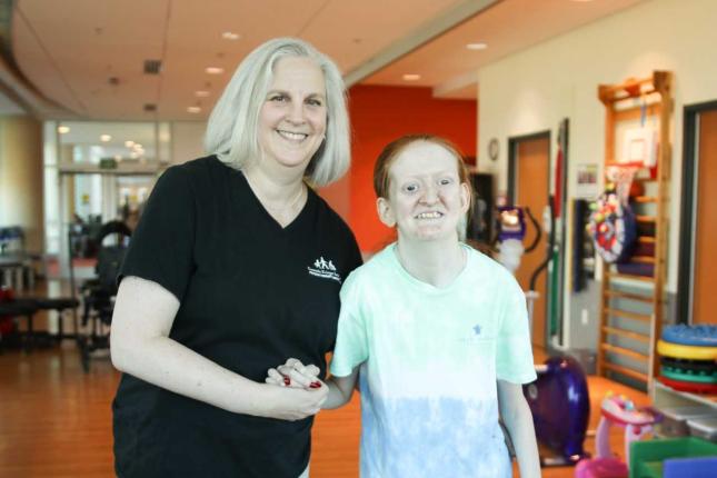 Heather McLean, Kennedy Krieger physical therapist, with Ellie
