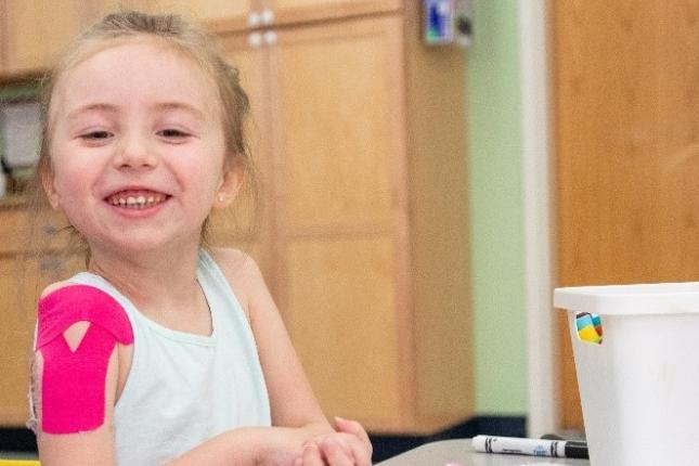 A photo of Ryleigh, a Kennedy Krieger patient with acute flaccid myelitis, during one of her therapy sessions