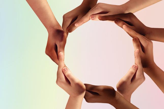 Hands of young children connected to make a circle