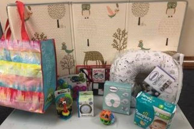 Assorted items for babies, put together in a bundle on a table.