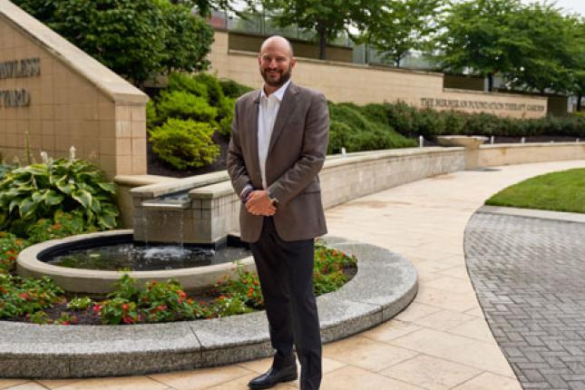 Dr. Brad Schlaggar stands in Kennedy Krieger Institute's therapy garden.