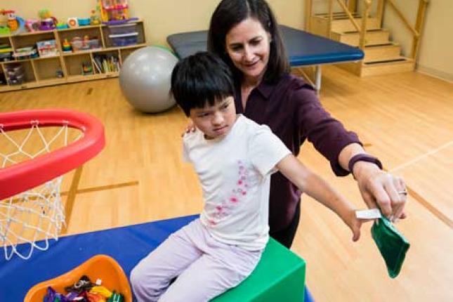 A doctor works with her patient. 
