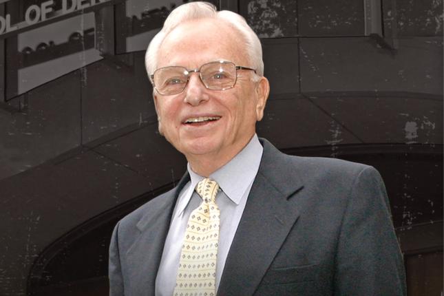 Portrait photo of a man in a suit and tie.