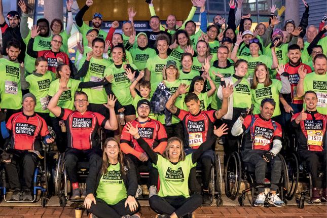 Team Kennedy Krieger poses for a photo in front of the Maryland Science Center before the 2022 Baltimore Running Festival.