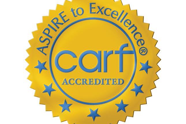 An icon shaped like an award seal that says: “Aspire to Excellence—CARF Accredited.”