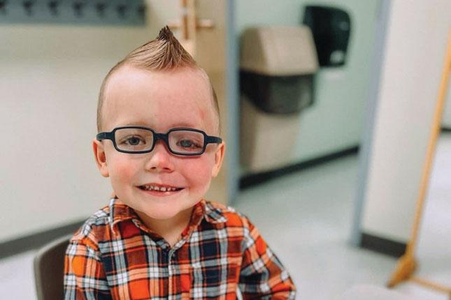 A young boy with Sturge-Weber syndrome smiles. 