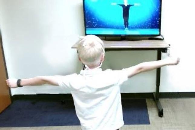 Un niño usa la herramienta para videojuegos de evaluación computarizada de imitación motora (CAMI)