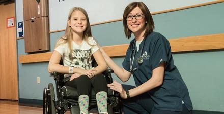 A nurse with a patient in the Pediatric Rehabilitation Unit