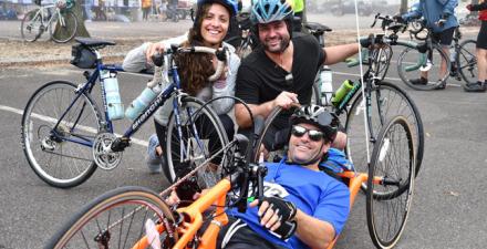 Hand cyclist Scott Sussman with man and woman as he gets ready for a race.