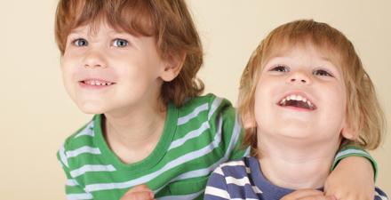 Two siblings smiling.