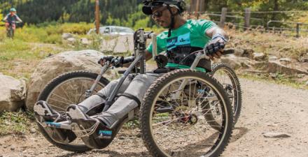 A person in a handcycle outside.