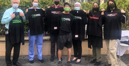 The Phelps Center team stands with a patient in Kennedy Krieger's therapy garden.