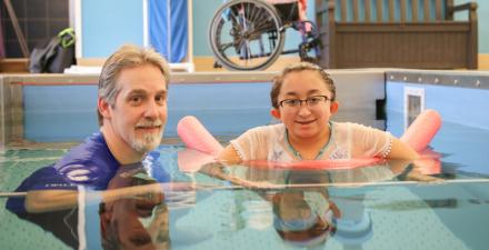 A young girl receives aquatic therapy from the International Center for Spinal Cord Injury.