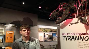 Justin poses with a model of a Tyrannosaurus Rex at the Smithsonian.