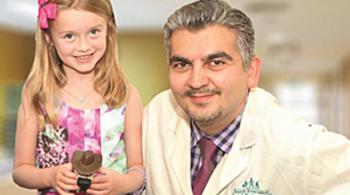 Kennedy Krieger patient Ellie McGinn poses with her doctor, Dr. Ali Fatemi
