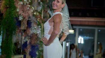 Model at Fall Fete, wearing a bright white dress and smiling.