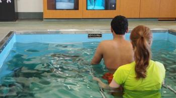 patient and therapist using the aquatic treadmill