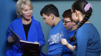 Nancy Grasmick reads a book to a group of children