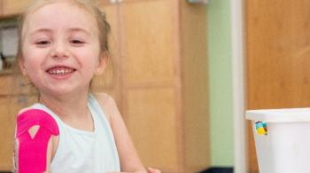 A photo of Ryleigh, a Kennedy Krieger patient with acute flaccid myelitis, during one of her therapy sessions