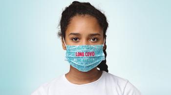 A young girl wears a facemask that says LONG COVID.