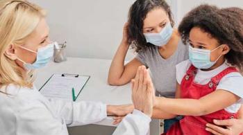 A child with her mother wearing protective face masks at an appointment with a doctor, a woman who is also wearing a face mask.