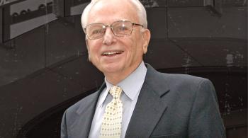 Portrait photo of a man in a suit and tie.