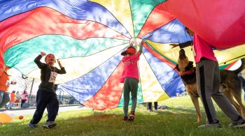 Photo of children at ROAR for Kids playing with a parachute