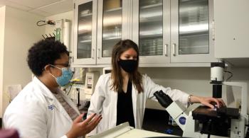 Two Kennedy Krieger researchers working in a lab. 