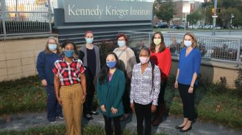 The Pediatric Post-COVID-19 Rehabilitation Clinic team stands in Kennedy Krieger Institute's therapy garden for a photo.