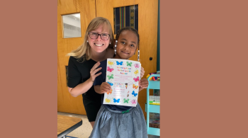 Aubree smiles with Kate Smidl, her speech therapist.