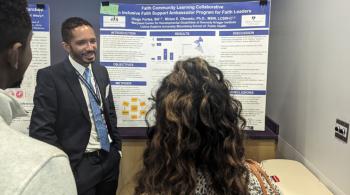 A man stands in front of a research poster and speaks to two people. The other two individuals have their backs to the camera.