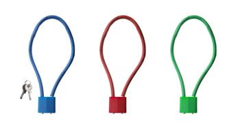Blue, red and green safe storage locks lay side-by-side against a white background. A key is lying next to the blue lock.