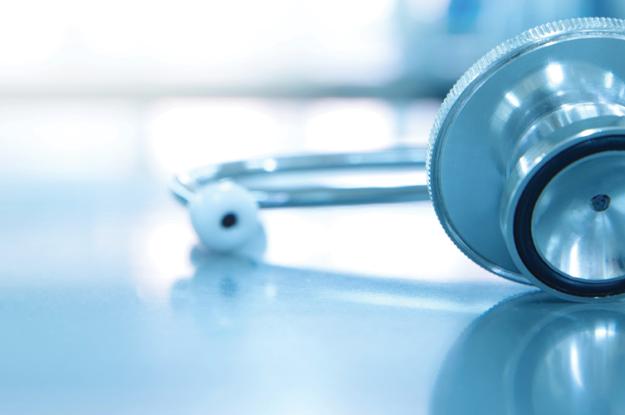 A stethoscope for sits on medical laboratory table. The background of the image is faded.