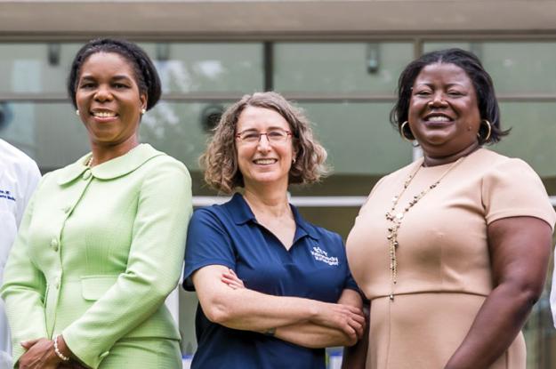 Five doctors stand in Kennedy Krieger Institute's therapy garden.