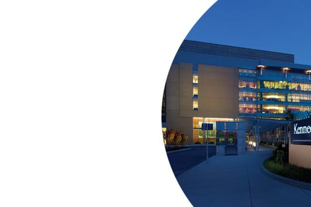 Exterior of Kennedy Krieger's main outpatient building at night.