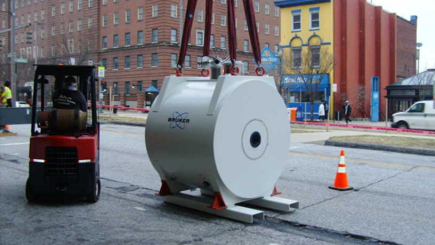 Magnet being lifted from transport trailer 