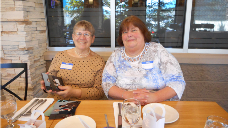 Two women sitting at a table. 